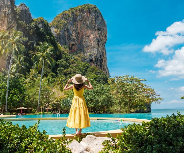 woman-tourist-in-yellow-dress-and-hat-traveling-on-railay-beach-krabi-thailand-vacation-travel.jpg